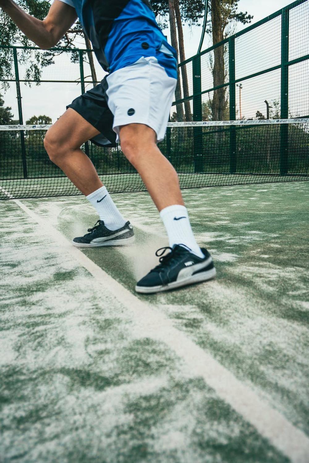 close_up_photo_of_man_standing_on_tennis_court