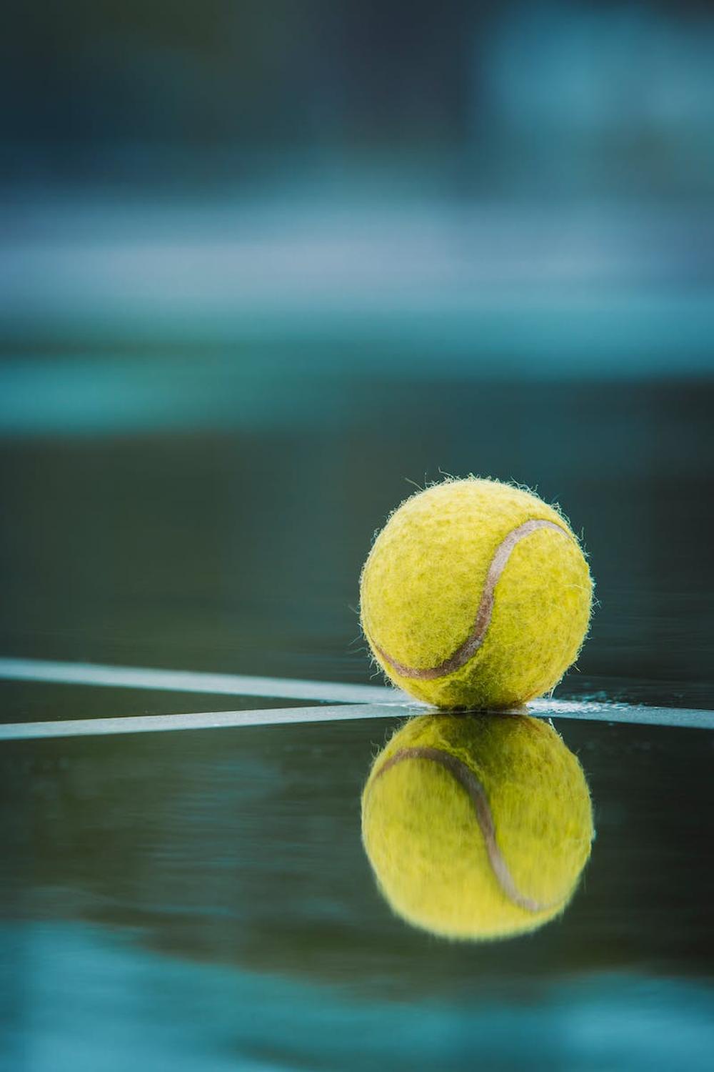 selective_focus_photography_of_tennis_ball_on_floo